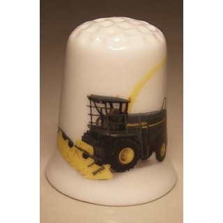 Dorsmachine op een porselein vingerhoedje Dorsmachine op een porselein vingerhoedje