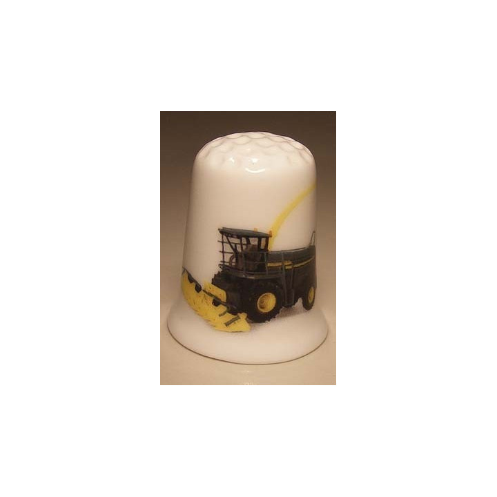 Dorsmachine op een porselein vingerhoedje Dorsmachine op een porselein vingerhoedje