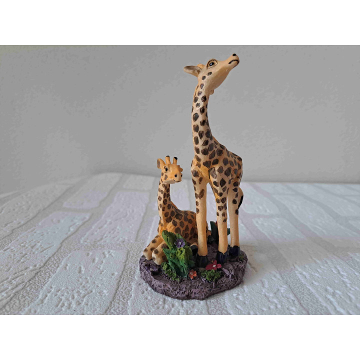 Moeder giraffe met liggend jong