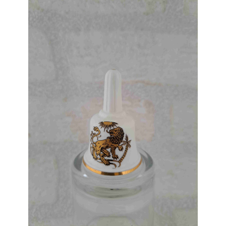 Porselein tafelbelletje met een goudkleurig leeuw sterrenbeeld opdruk