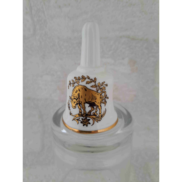 Porselein tafelbelletje met een goudkleurig stier sterrenbeeld opdruk