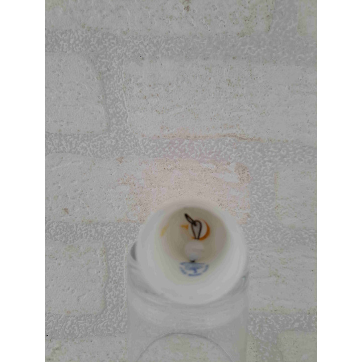 Porselein tafelbelletje met een goudkleurig waterman sterrenbeeld opdruk