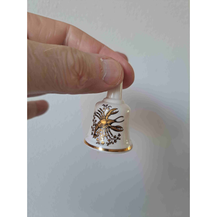 Porselein tafelbelletje goudkleurig kreeft sterrenbeeld