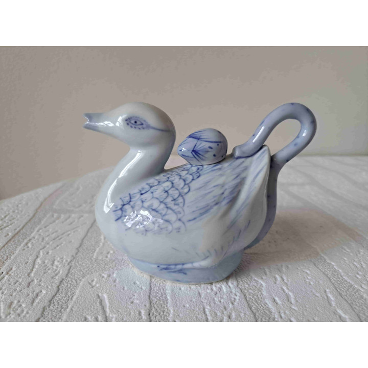 Theepotje van hotel porselein in een vorm van een eend met jong