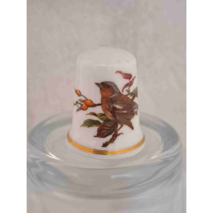 Vinkel vogel op een porselein vingerhoedje met goud randje Vinkel vogel op een porselein vingerhoedje met goud randje