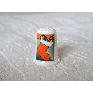 Kerstsok aan de open haard vingerhoedje