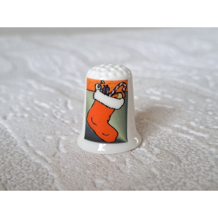 Kerstsok aan de open haard vingerhoedje